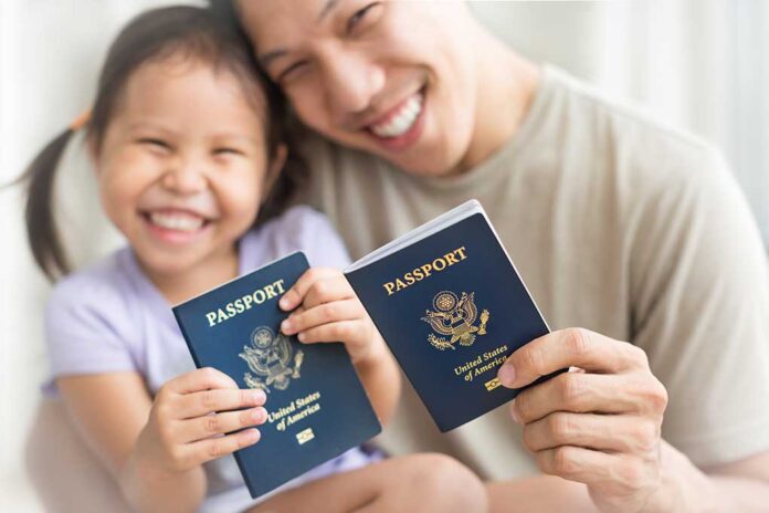 Asian,Dad,And,Daughter,Holding,Amercian,Passports,With,Pride.,Immigration