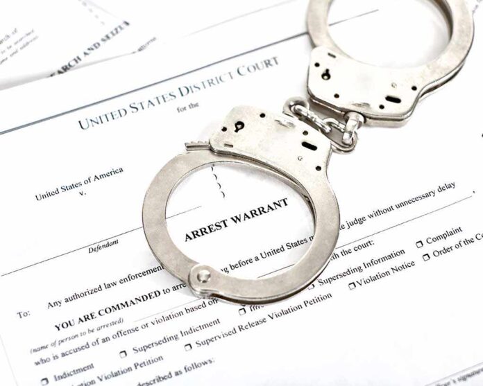District,Court,Arrest,Warrant,Court,Papers,With,Handcuffs,Isolated,On