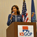 Woman speaking at KS GOP event podium.