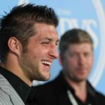 Tim Tebow smiling at an event.