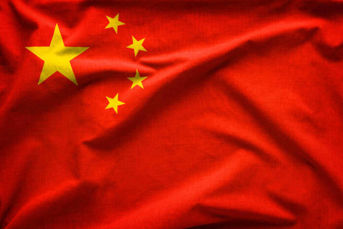 shutterstock_12866732531.jpg featured image Chinese flag with five yellow stars.
