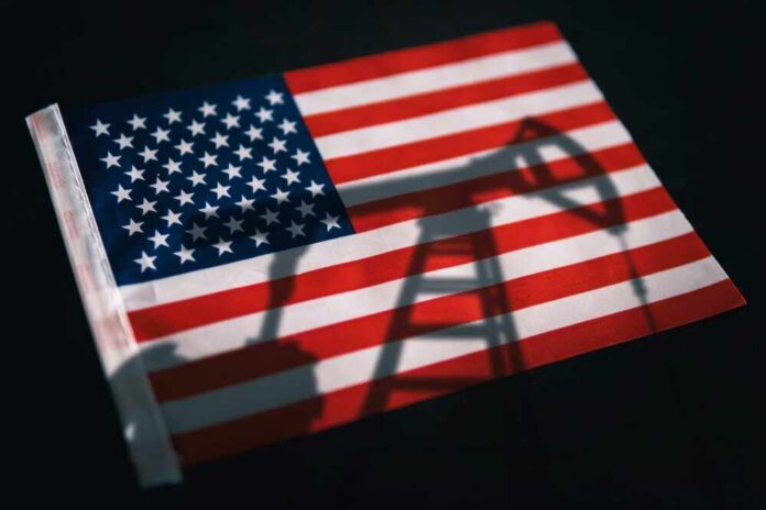 shutterstock_2277946563.jpg featured image American flag with oil pump shadow overlay.