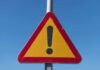 Triangular warning sign with exclamation mark.