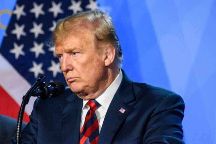 shutterstock_1358576063-1.jpg featured image Donald Trump speaks at a podium.