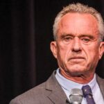 Robert F. Kennedy JR holding microphone.