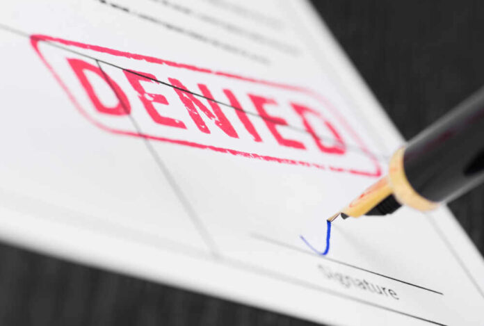 shutterstock_1058833358.jpg featured image Denied stamp and pen signing document
