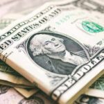 U.S. dollar bills with George Washington visible.