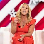 Marjory Taylor Green, MTG, speaking at an event in red dress.