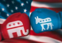 Red Republican glove and blue Democrat glove facing off.