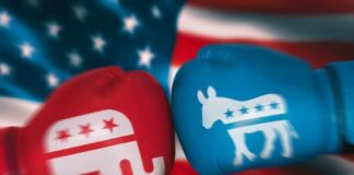 Red Republican glove and blue Democrat glove facing off.