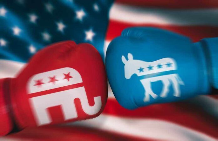 Red Republican glove and blue Democrat glove facing off.