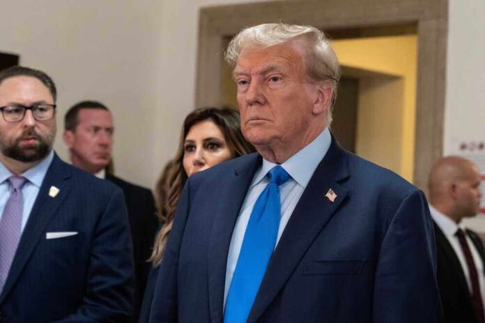 Donald Trump in formal attire standing indoors.