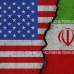 United States and Iran flags divided by crack