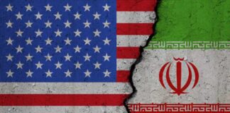 United States and Iran flags divided by crack