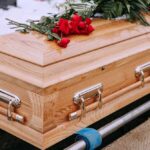 Wooden casket with red roses on top