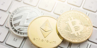 Litecoin, Ethereum, and Bitcoin coins on a keyboard.