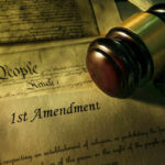 Gavel and Constitution with 1st Amendment text.
