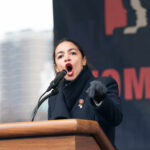 WATCH: AOC’s ANGER Unleashed on Senate’s TIP TAX Alexandria Ocasio-Cortez passionately speaking at a podium outside.