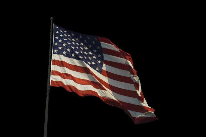 American flag waving against a black background