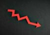 Red zigzag arrow pointing down on dark background.