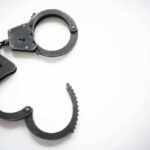 Richard Tillman Arrest Shocks Nation Open metal handcuffs on white background