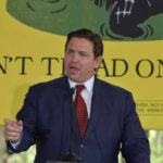 Ron DeSantis speaking at a podium