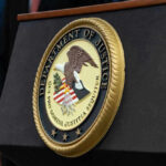 Department of Justice seal on a podium