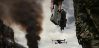 Drone commanded by military personnel holding a controller