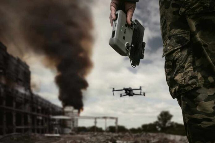 Drone commanded by military personnel holding a controller
