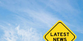 Yellow sign with text Latest News on sky background