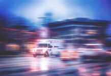 Ambulance speeding through city street