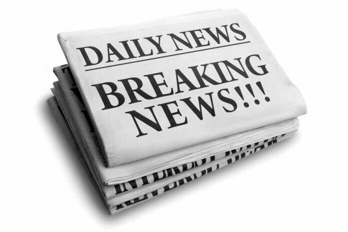 Stack of newspapers with breaking news headline