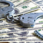 Secret Service RAIDS — Stunning $44 Million Crime Handcuffs on a pile of one hundred dollar bills.