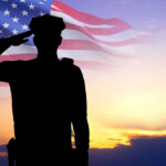 This War Hero’s Death Closes WWII Fighter Ace Chapter Silhouette of soldier saluting in front of flag