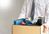 Person holding a box of personal office items