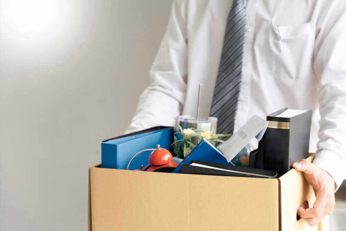 Person holding a box of personal office items