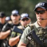 SWAT team members in tactical gear during a training exercise