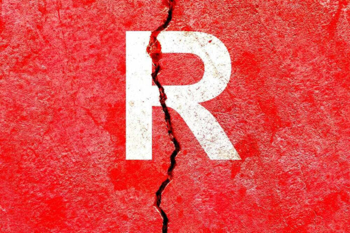 Cracked red wall with white letter R