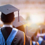 Graduates wearing caps and gowns in a ceremony