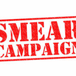 Red stamp graphic with the words SMEAR CAMPAIGN