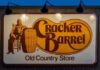 Cracker Barrel restaurant sign featuring a seated figure and a barrel