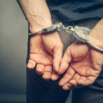 Massive Heist Crew ARRESTED! Person with handcuffs behind their back