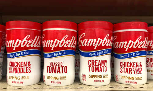 Various Campbell's soup containers on a grocery shelf