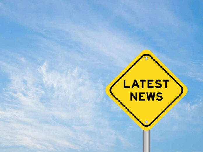 shutterstock_2530090361.jpg Yellow sign with text Latest News on sky background