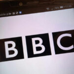 Close-up of a mobile phone displaying the BBC logo