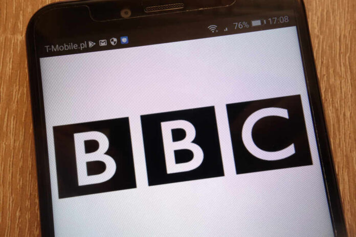 Close-up of a mobile phone displaying the BBC logo
