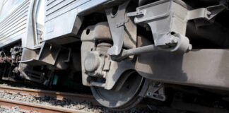 Close-up view of a train wheel on railway tracks