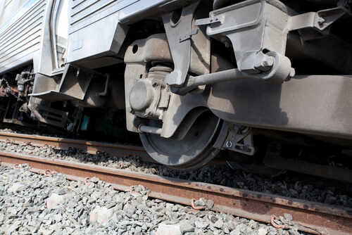 Close-up view of a train wheel on railway tracks