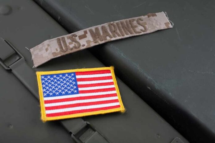 Military patches including a US Marines insignia and an American flag on a green surface