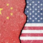 Cracked surface revealing the flags of China and the USA